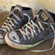 homeless: A teen's well-worn, drawn on Converse All-Star sneakers, with the laces painted in rainbow colors