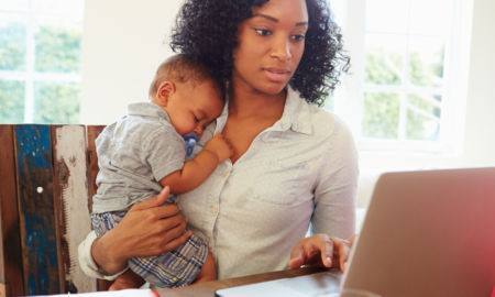 D.C. Area Women,Children, Family and Jobs grants; mother research online while holding child
