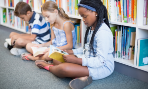 k-9 reading program grants; children on school library floor reading books