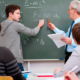 youth summer math program grants; student doing math on blackboard with teacher