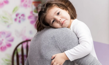 number of uninsured children on the rise report; sad child hugging parent
