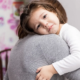 number of uninsured children on the rise report; sad child hugging parent