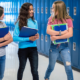 school segregation report; young female students walking down school hallway