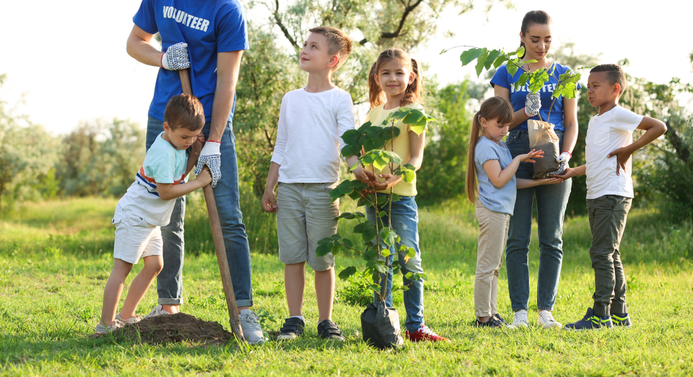 community and K-12 environmental project grants, Grand Rapids grant; young children planting trees led by volunteers