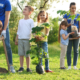 community and K-12 environmental education project grants; young children planting trees led by volunteers