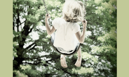 Oklahoma community grants; young child swinging on swing