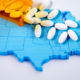 rural opioid abuse; bottle of pills being spilled over map of U.S.
