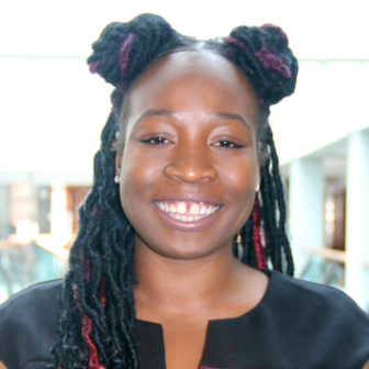 opportunity youth: Shawnice Jackson (headshot), Baltimore consultant, writer, activist, smiling woman with 2 afropuffs 