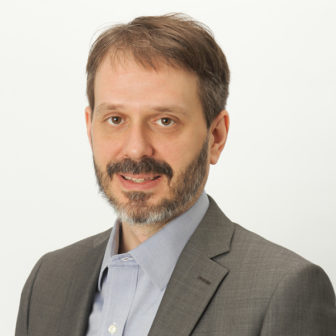 epidemic: Charles Ransford (headshot), senior director of science, policy for Cure Violence, man with short light brown hair, beard, mustache, gray jacket, light blue shirt