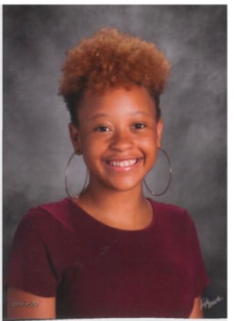 Philadelphia: Dhmyni Samuels (headshot), a junior at Germantown Friends School, smiling teen with light brown hair, hoop earrings 