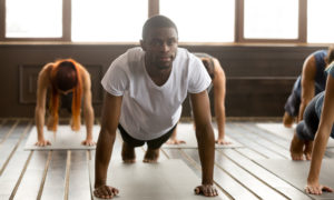 HOPE Court: young black man in yoga class standing in plank pose