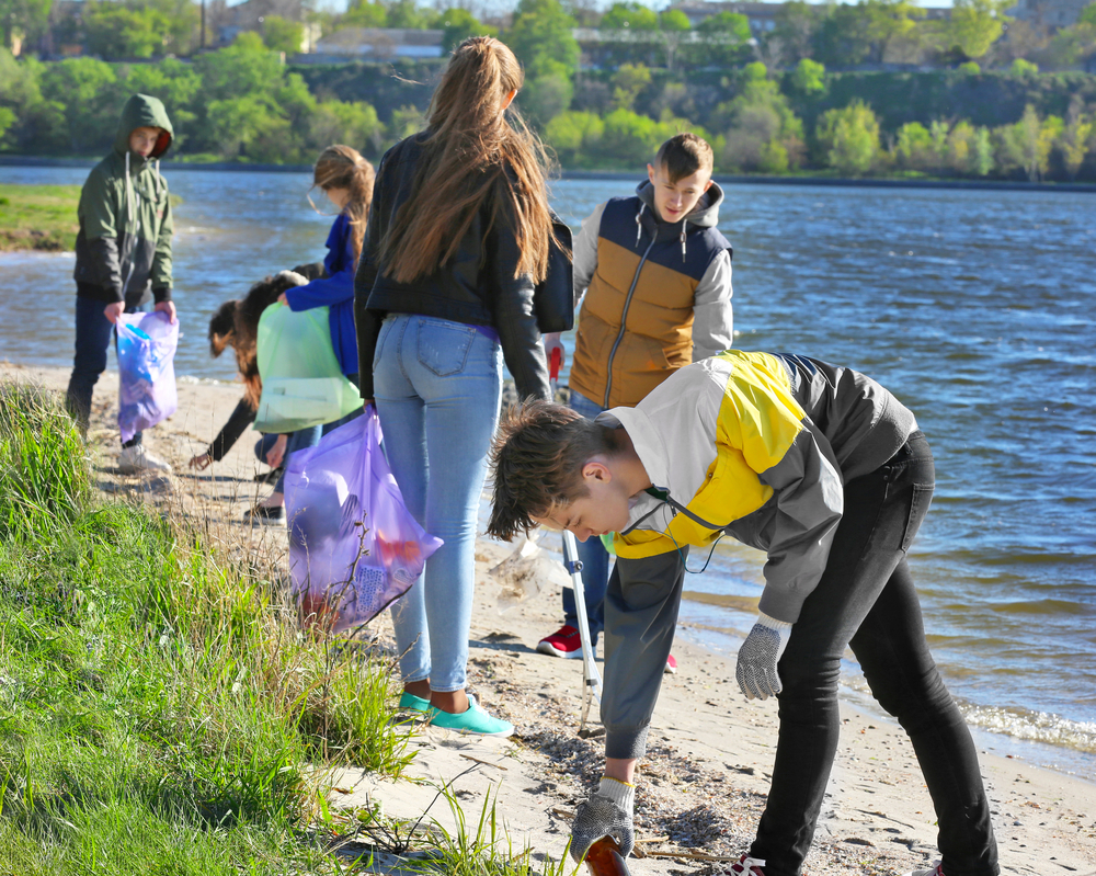 community service: Young people cleaning beach area. 