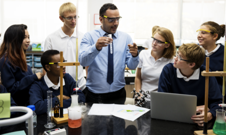 middle and high school science teacher award grants; male science teacher showing students test tube
