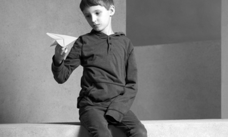 NY,MA youth with disabilities and mental health issues grants; young boy playing with paper airplane