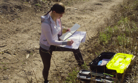 environment job and career grant graphic, young woman doing survey work in the field