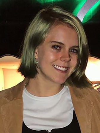 gang database: Smiling young woman wearing earrings, jacket