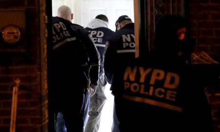 gang database: Rear view of men wearing coats with NYPD Police on it