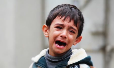 New Mexico: Little boy wearing a jacket crying