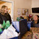 Santa Fe: 2 women smile at each other as they wrap very large presents