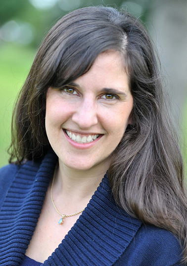 Jessica Foster newsmaker headshot; dark-haired woman in sweater smiling at camera