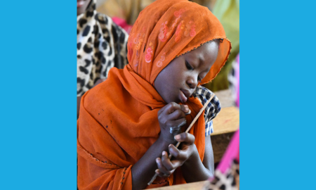 Addressing the learning crisis UNICEF report cover; young girl in headscarf learning in class