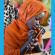 Addressing the learning crisis UNICEF report cover; young girl in headscarf learning in class