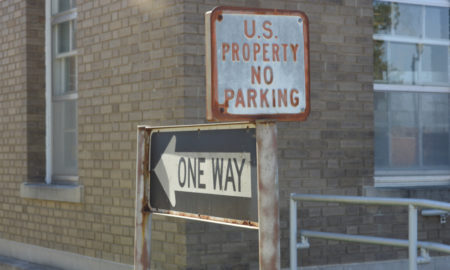 poverty: A one way sign, next to U.S. property no parking sign