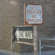poverty: A one way sign, next to U.S. property no parking sign