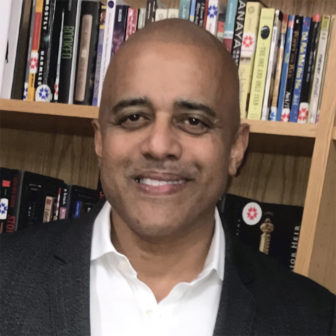 New York: Jeremy C. Kohomban (headshot), president, CEO of Children’s Village, smiling man with shaved head in front of bookcase