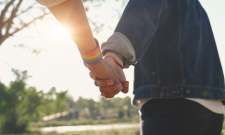 Suicidality Disparities by Sexual Identity persisting into adulthood report; young LGBT couple holding hands