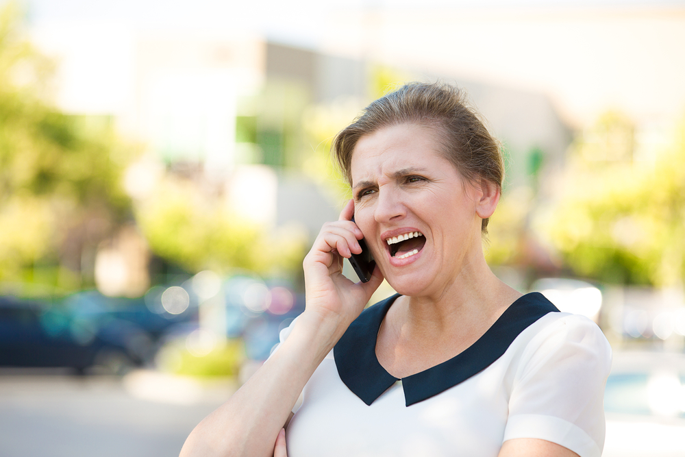 mandatory reporting: Angry Woman Screaming while Talking on mobile Phone