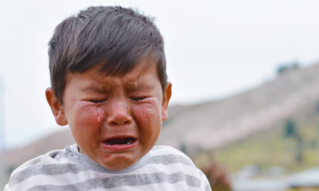 neglect: Little latino boy crying outdoors
