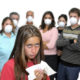 afterschool: Big group of people with masks and one isolated sick child with the flu