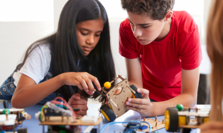 Grades 6-12 STEM Education Project grants; two students working on device