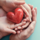 Midwest early childhood program grants graphic, hands of family holding heart