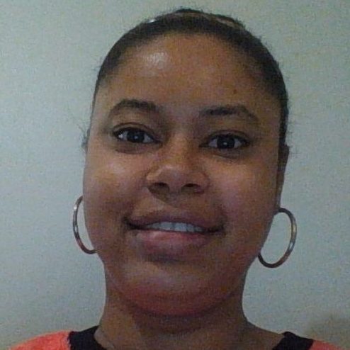 mental health: disabilities, : Deandra Mouzon (headshot), Georgia-based journalist, smiling woman with black hair, earrings, orange top