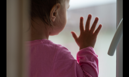 Child Sexual Abuse Prevention Program Support During COVID Grants; young child staring out with hand on window