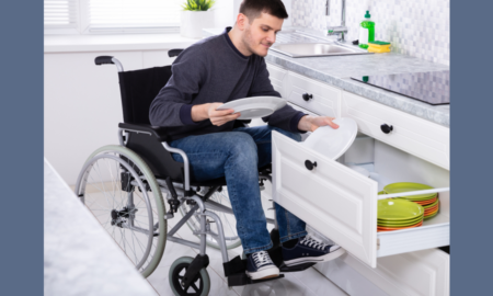 Developing Alternatives to Guardianship for Youth w/ Disabilties Grants; young man in wheelchair in home putting dishes away