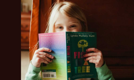 Education, Children's Advocacy, Healthcare, Arts program grants; young happy girl reading a book