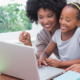 Southern Black Girls and Women support grants; young black mother and daughter happy on laptop