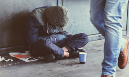 Youth Homelessness Prevalence Research Grant; young homeless man sitting on street with head down