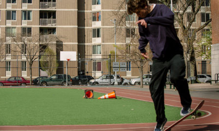 Boy on skateboard on basketball court