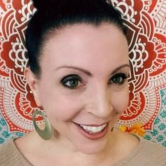 trauma: Anna Nelson (headshot), assistant professor of social work at New Mexico State University’s School of Social Work, smiling woman with dark hair, earrings, beige top