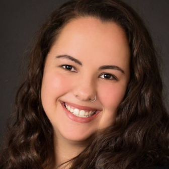 homelessness: Jordyn Roark (headshot), director of youth leadership, scholarships at SchoolHouse Connection, woman smiling with nose ring, long brown hair