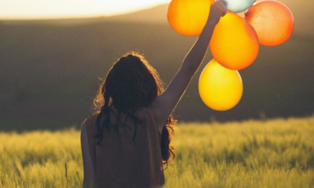 A Global Framework for Youth Mental Health Report Cover; young woman holding balloons in a field