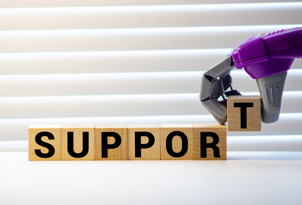 ableism: Support sign with wooden blocks placed by robot arm