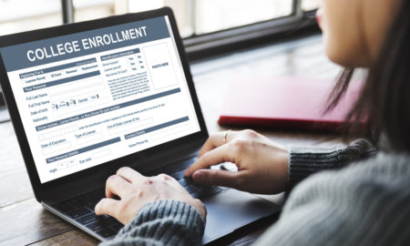 Woman works on college enrollment website.