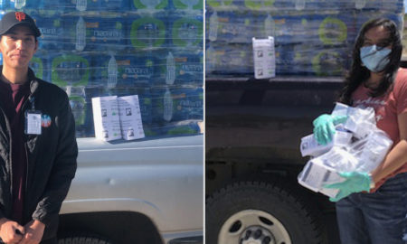 tag: Man in black jacket, ball cap stands in front of truck full of cases of water, woman in orange T-shirt, blue jeans carries items off the truck