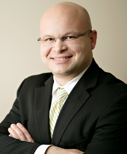 Armando Camacho Named President and CEO of Wilder Foundation; bald man in glasses and suit headshot