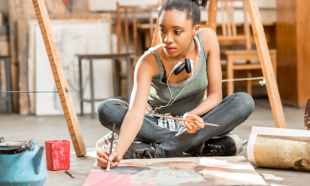 Black, Indigenous and People of Color Artist and Arts Administrator Support Small Grants; young black woman painting on floor